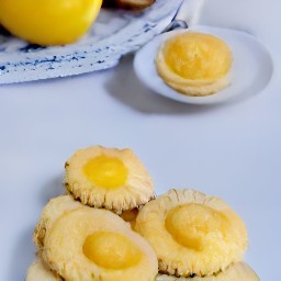 the lemon curd is on top of the grilled all-butter shortbreads.