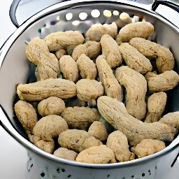 the green peanuts are drained in a colander.