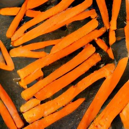 the carrots are transferred to a baking sheet.