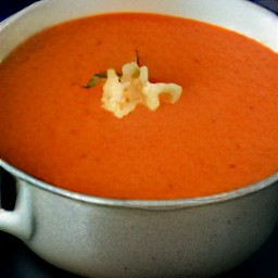 a bowl of tomato soup with butter, onions, oregano, garlic, cayenne pepper, flour, and sugar.