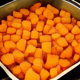 the output is a roasting tin with sweet potato chunks and carrots chunks spread out, drizzled with olive oil, and sprinkled with salt and black pepper.