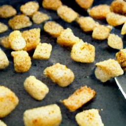 a baking sheet with sourdough bread cubes and olive oil.