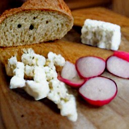 radishes that are peeled and diced, feta cheese that is crumbled, and sourdough bread that is cut into cubes.