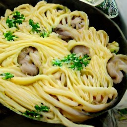 a dish of linguine with portabella mushrooms, basil, and parmesan cheese.