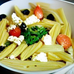 a bowl of greek penne pasta with crumbled feta cheese and chopped black olives.