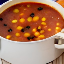 a pot of soup with refried beans, vegetable stock, black beans, corn, rotel tomatoes and chilies.