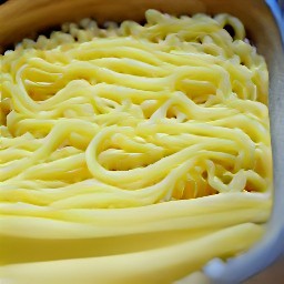 the egg noodles mixture is poured into a baking dish and topped with the rest of the melted butter.