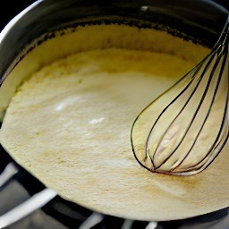 the egg mixture is transferred to the milk-flour mixture and whisked to form a batter.