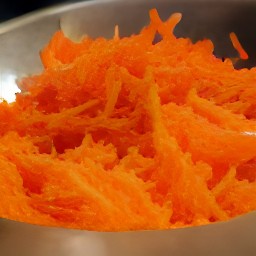 the carrots are shredded into thin pieces.