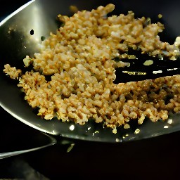 a wok with vegetable oil, ginger, and garlic that has been fried for 2 minutes.