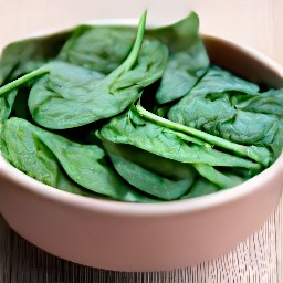 a salad made of 6 oz of broccolis and spinach, mixed together using a spoon.