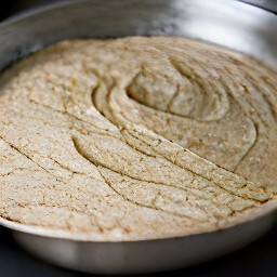 the dough spread out on a pan. it will then be set aside in a warm place for 80 minutes.