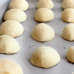 the dough balls are brushed with half a cup of milk.
