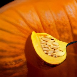 the seeds from the halved pumpkin have been scooped out.