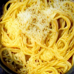 a plate of linguine pasta with butter, garlic, lemon juice, and salt sprinkled on top.