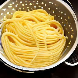 the pasta is drained in a colander.