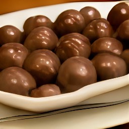 the choco-peanut balls are taken out of the refrigerator and served on a platter.
