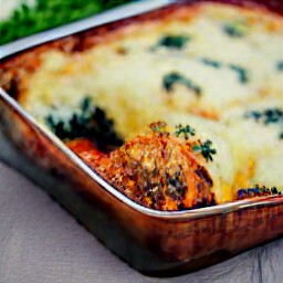 the lasagna spirals are taken out of the oven in a baking dish.