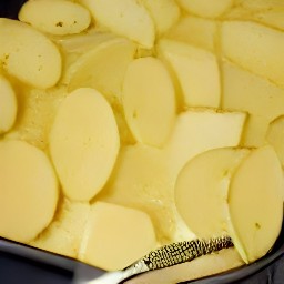 the potato slices are covered in a thin layer of butter.