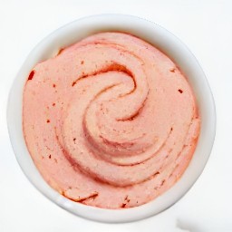 a bowl of mixed contents with added strawberries.