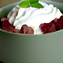 a rhubarb pudding served with cream on top.