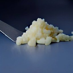 onions and garlic that are peeled and chopped, and baby greens that are cut into thin slices.
