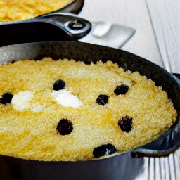 a mixture in a pan with raisins and flaked coconut.