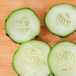 a peeled cucumber that has been cut into slices.