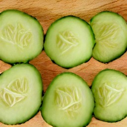 cucumbers that are sliced with a knife.