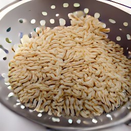 cooked rice in a colander with water poured over it to cool, then drained.