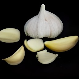 garlic that has been peeled and parsley that has been chopped.