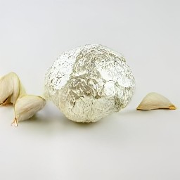 the garlic cloves are wrapped in aluminium foil.