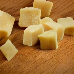 the parmesan cheese is cut into small cubes.