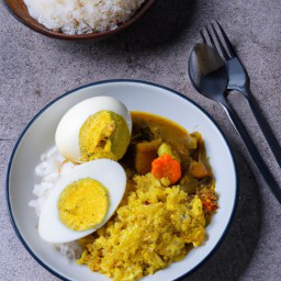 

Egg curry with rice and lentil is a delicious Indian dinner or lunch, made of red onions, ginger, tomatoes, eggs coriander and basmati rice. It's beans-and-grains packed meal that also includes red lentils alongside naan bread and green chili peppers - all without nuts!