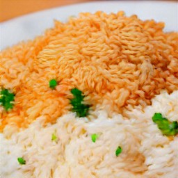 the white rice and lentil are transferred to a plate.