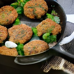flipping semi cooked patties with a spoon.