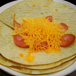 a corn tortilla is placed on a plate and covered with tomato slices, cheddar cheese, and another corn tortilla.