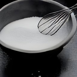 a bowl of granulated sugar and buttermilk that has been whisked together.