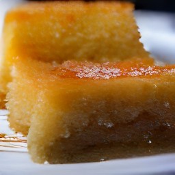 a platter with a baking pan on it, drizzled with lemon syrup.