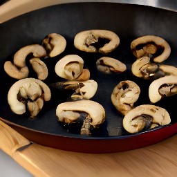 a skillet pan with portabella mushroom slices that have been stir-fried for 3 minutes.