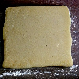 the dough should be shaped into a rectangle on a board, using a rolling pin.