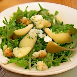 the salad will have arugula as the base, with cooked pears and walnuts on top. the juice from the cooking process used as a dressing, and blue cheese slices used as a garnish.