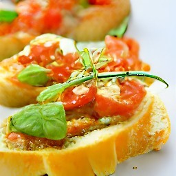 the bruschetta with pesto tomatoes is transferred to a platter.