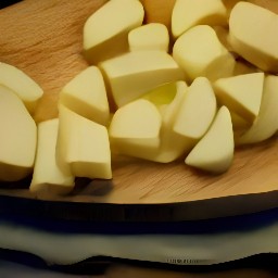potatoes that are cut into chunks and peeled garlic.