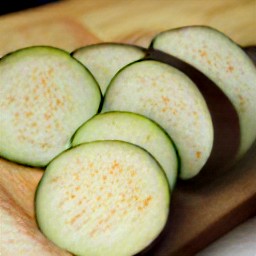 after peeling the onions and garlic, chop them into small pieces. then, slice the eggplant into thin slices.