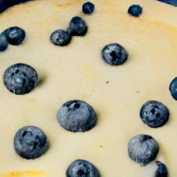 a cake pan with blueberries and crumble scattered over it.