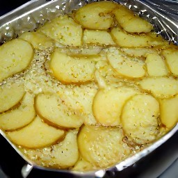 a dish with potatoes, cheese, and onion sauce.