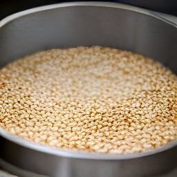 the sugar mixture is poured into the cake pan and set aside for 5 minutes. then, the rest of the toasted sesame seeds are sprinkled on top.
