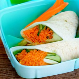 the cheese and salad wraps are in a lunchbox.