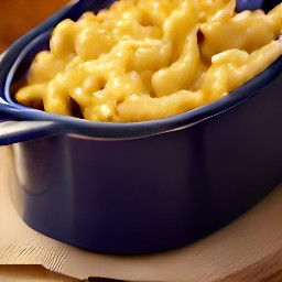 a casserole dish containing a mixture of one-quarter melted butter, sliced cheddar cheese, macaroni pasta, and egg mixture, with the remaining melted butter stirred in and cracker crumbs sprinkled